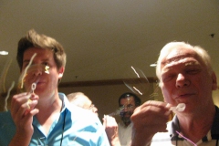 Jeremy Keene, Paul Susi (hidden) and Michael Riley blowing bubbles at the social