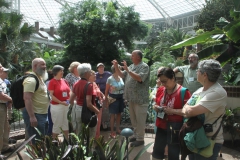 Tour group and guide out in one of the conservatories