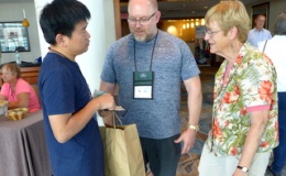 Greeting old friends and new at Registration: Qiu Zhi-Jing, Winston Goretsky, and Betsy Gottshall