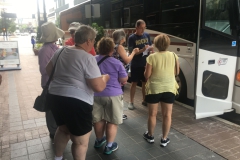 Tour attendees loading onto tour bus