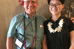 Stephen and student Wendy wearing leis made by Hong Xin