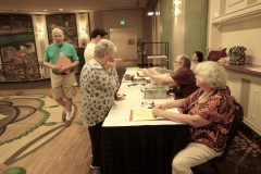 Registration area with volunteers Irina Nicholson and Austin Grievous