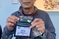 Hung Nguyen selling the 2022 Society pin he designed