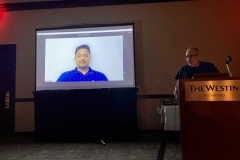 Speakers Chair Paul Susi introducing Prasanna NS from India by satellite