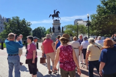 Tour group back outside nearing the monument honoring George Washington